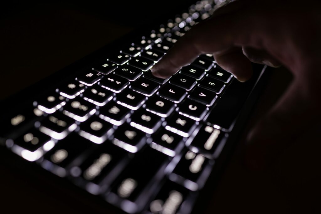 person holding black computer keyboard