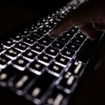 person holding black computer keyboard